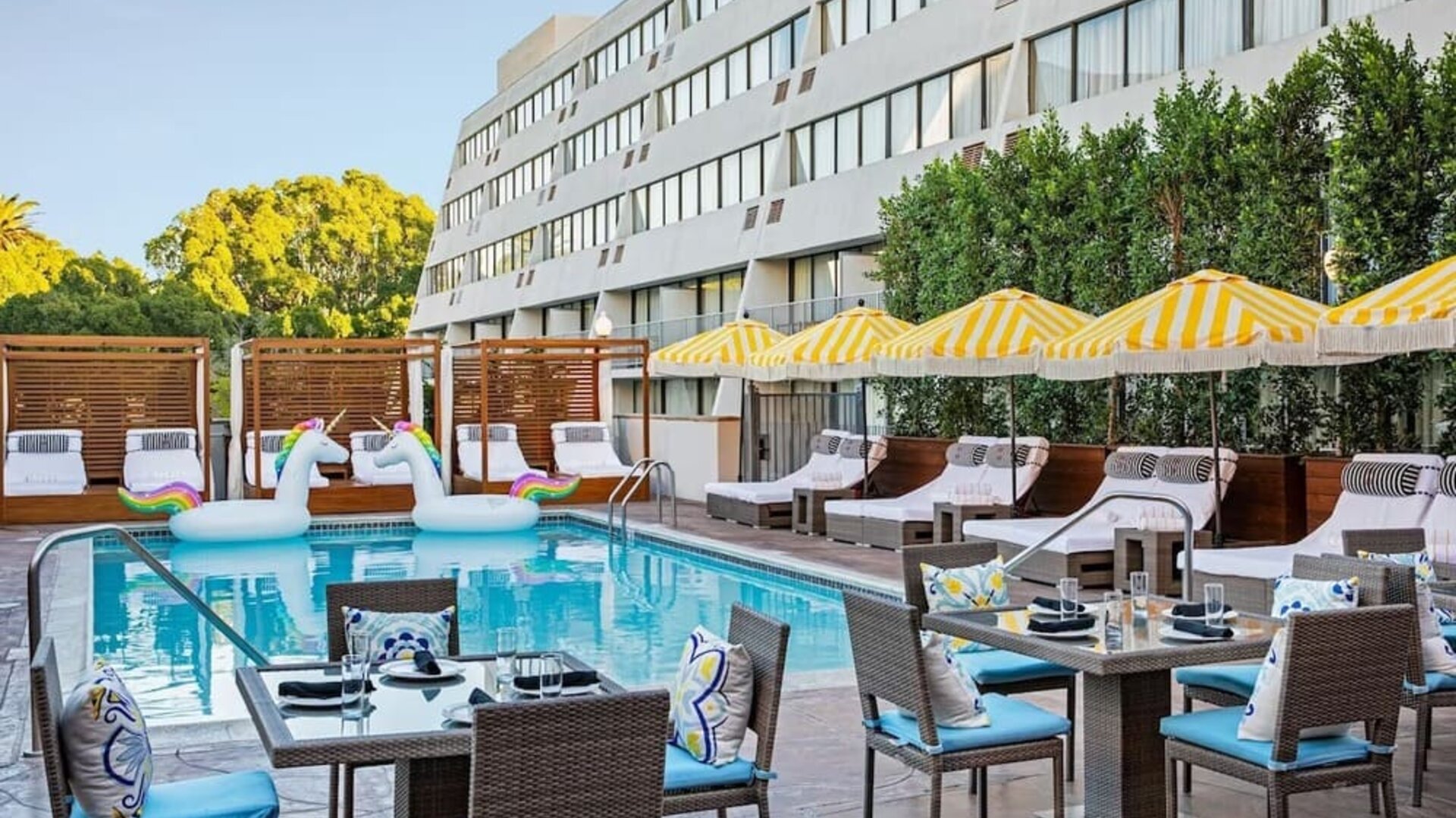 Outdoor pool with surrounding seating area at Hotel Dena, Pasadena Los Angeles.