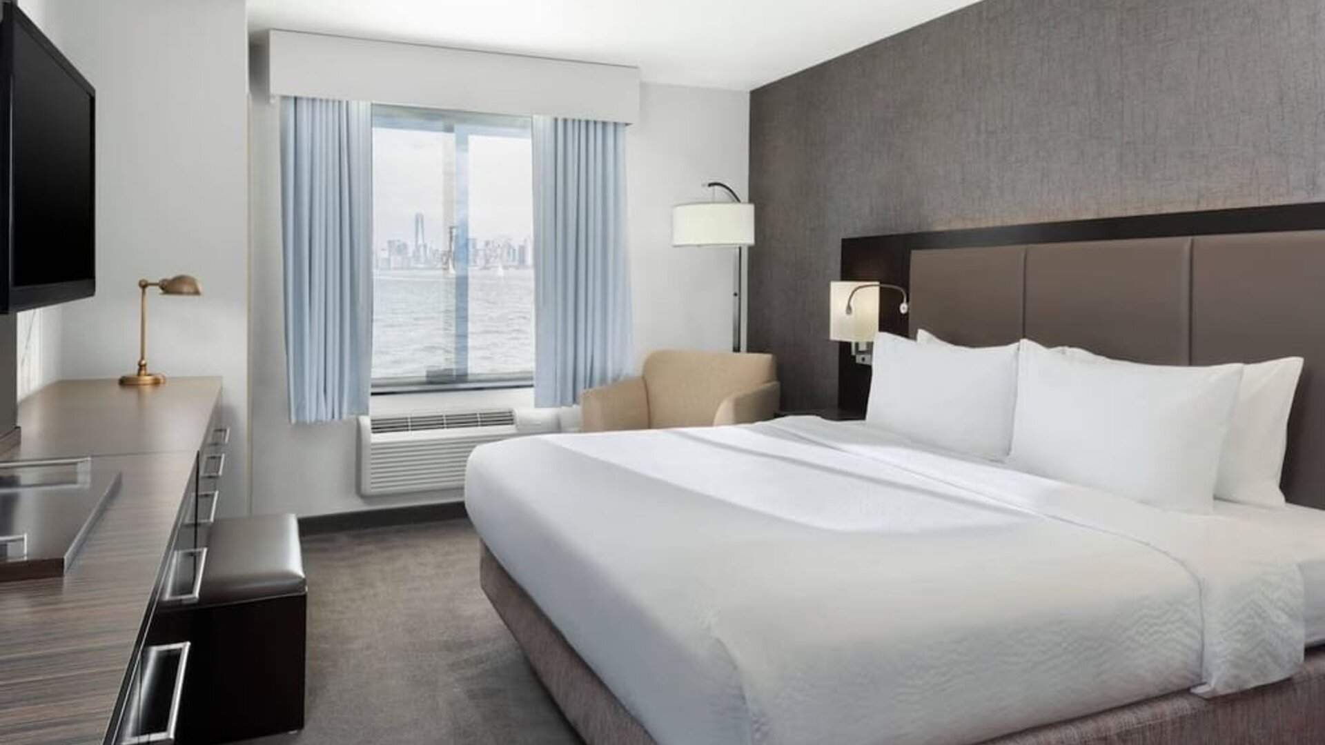 Day use room with TV and natural light at Fairfield Inn & Suites By Marriott New York Staten Island.