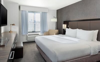 Day use room with TV and natural light at Fairfield Inn & Suites By Marriott New York Staten Island.