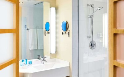 Guest bathroom with shower at Novotel Toronto North York.