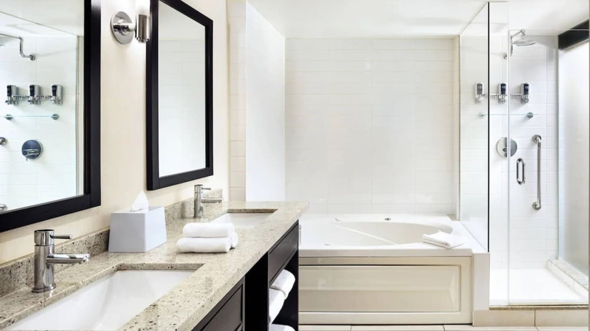 Guest bathroom with shower and bath at Four Points By Sheraton Mississauga Meadowvale.