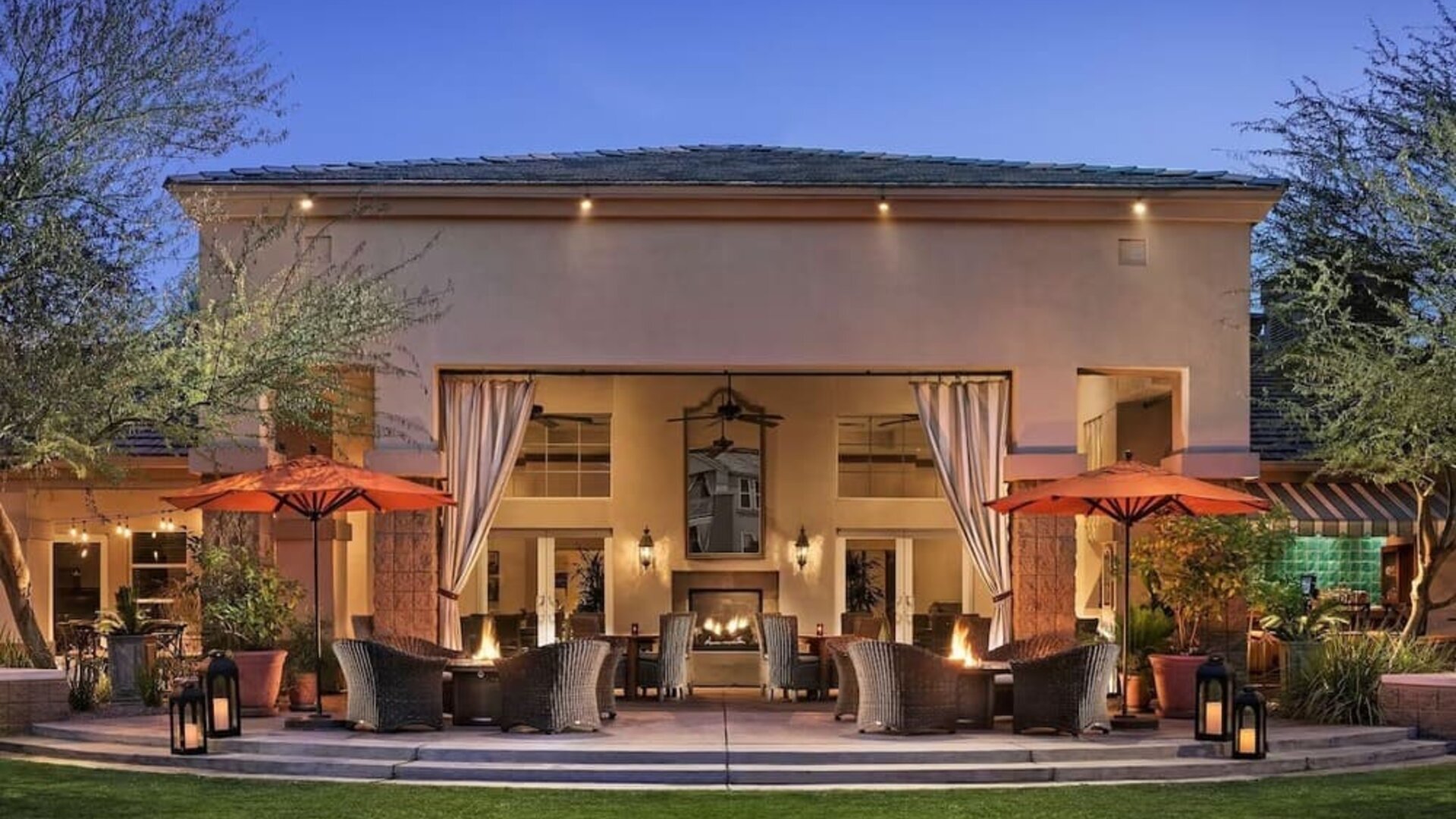 Hotel exterior with outdoor seating at Sonesta Suites Scottsdale Gainey Ranch.
