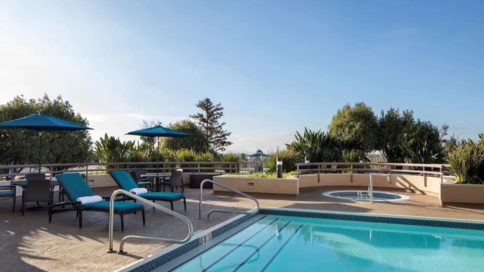 Outdoor pool with seating area at Sonesta San Jose.