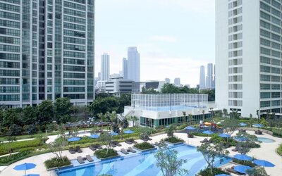 Outdoor pool with lounge chairs at Fraser Place Setiabudi Jakarta.