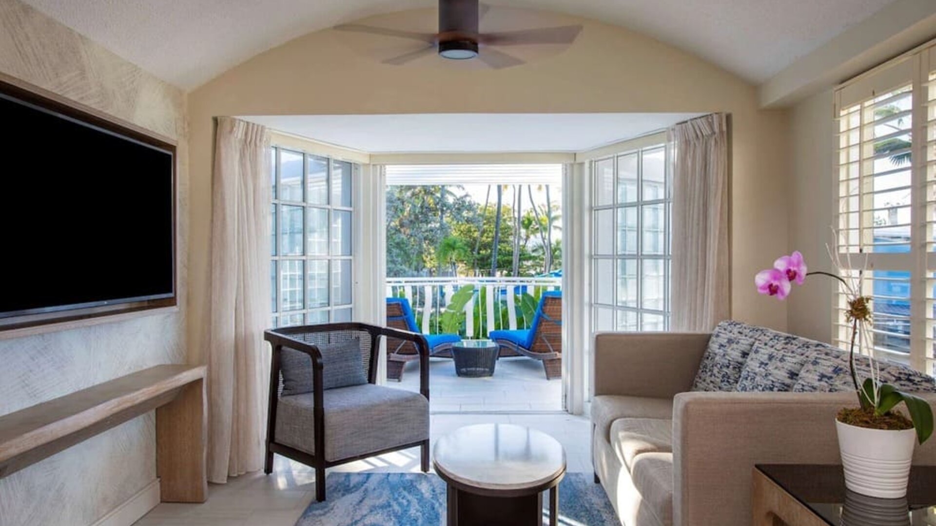 Spacious king room with TV and lounge at Royal Sonesta San Juan.