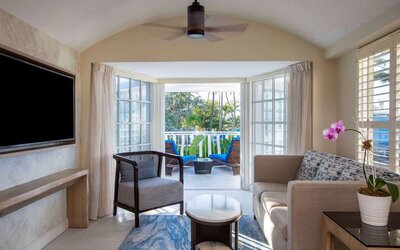 Spacious king room with TV and lounge at Royal Sonesta San Juan.