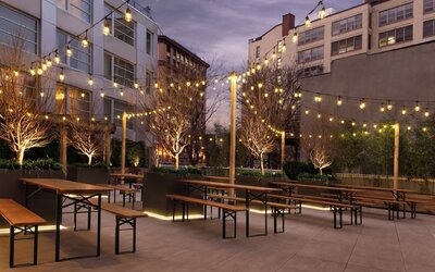 Outdoor lounge with night lights at The Tillary Hotel.