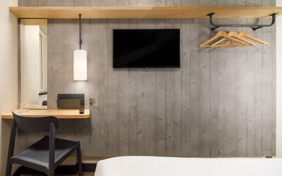 Day room with TV and work desk at Ibis Budget Manchester Airport.