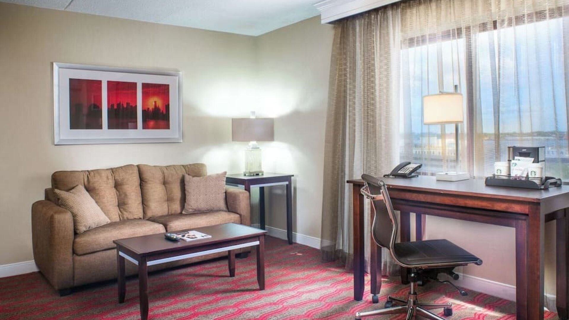 King room with lounge and work desk at Laguardia Plaza Hotel.