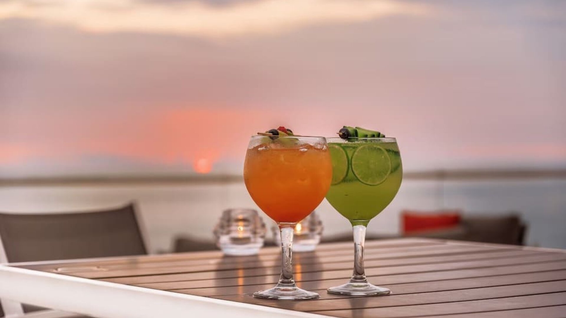 Outdoor terrace and drinks at Grand Miramar All Luxury Suites & Residences.