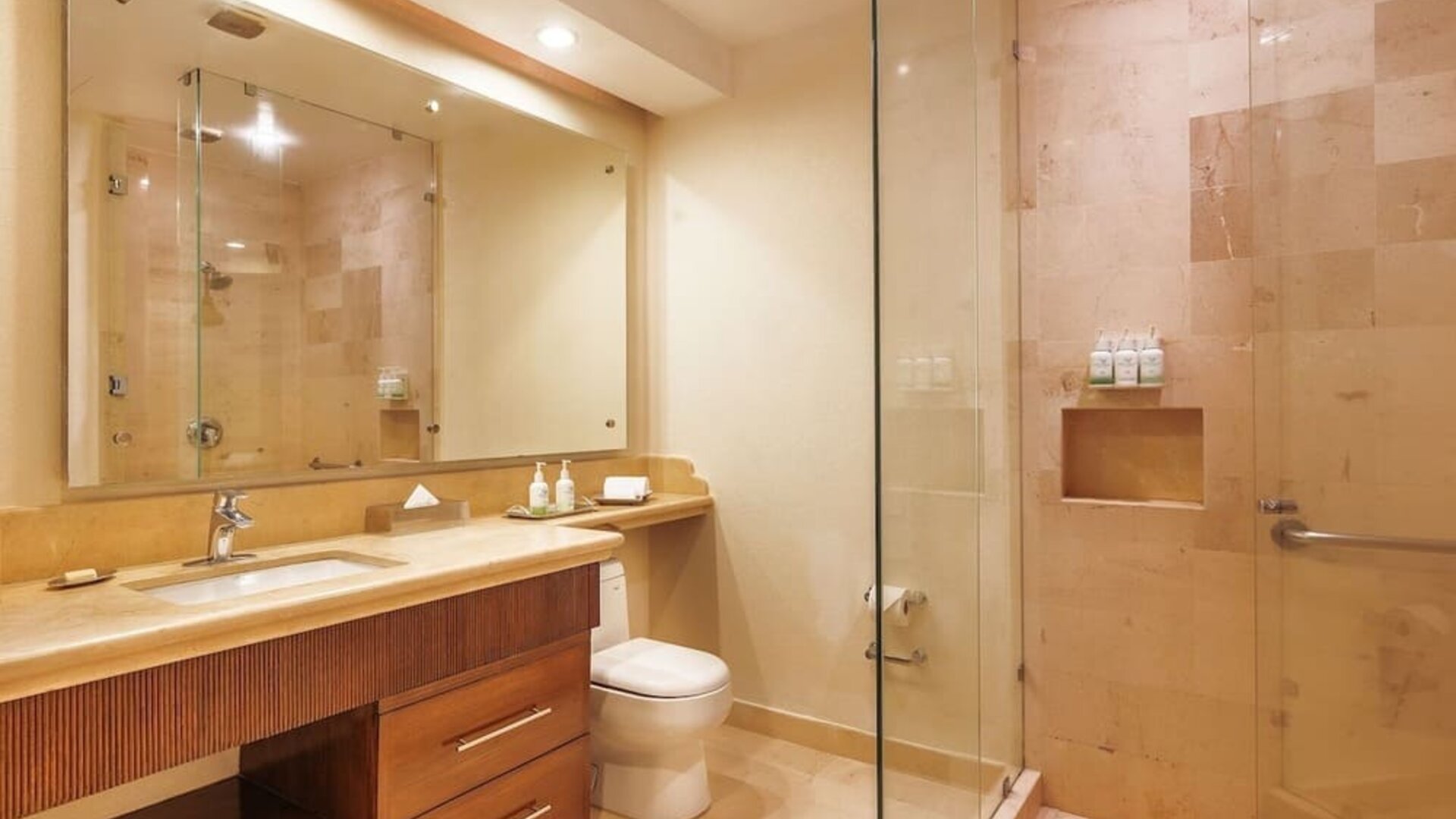 Guest bathroom with shower at Grand Miramar All Luxury Suites & Residences.
