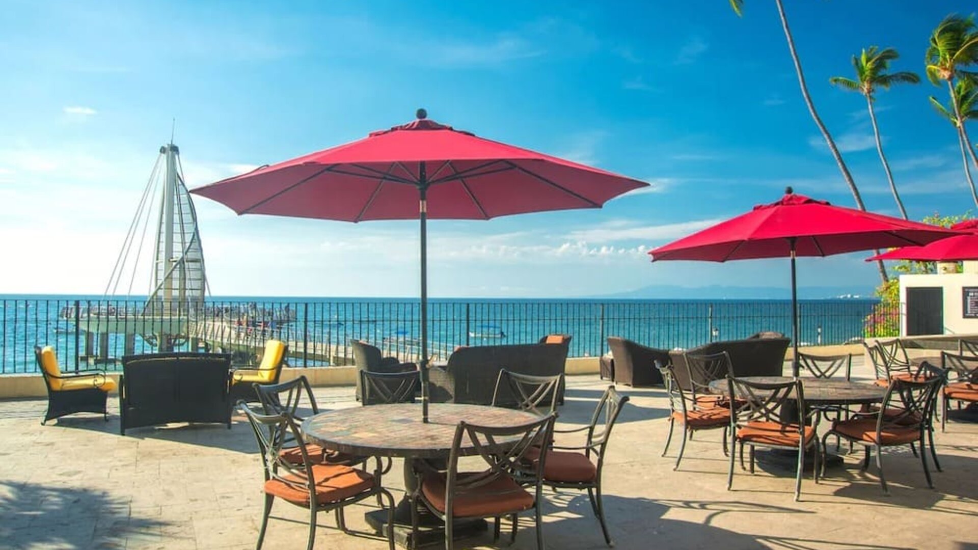 Outdoor terrace and seating area at Hotel Delfin PV Beach Resort.