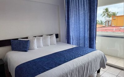 Cozy king room with terrace at Hotel Delfin PV Beach Resort.