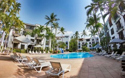 Outdoor pool with pool loungers at Puerto De Luna Pet Friendly & Family Suites.