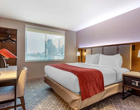 Day use room with work desk and natural light at Comfort Inn JFK Airport.