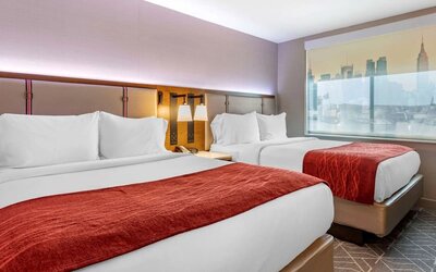 Twin bedroom with natural light at Comfort Inn JFK Airport.