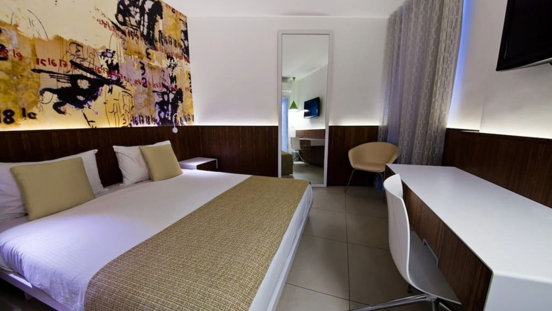 King room with TV and work station at Prima Vera Hotel.