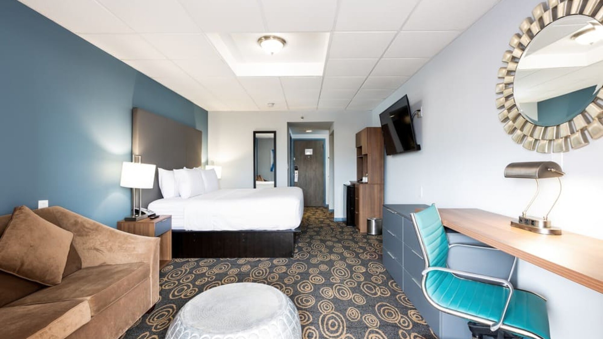 Spacious king room with lounge area at Regency Miami Airport By Sonesta.