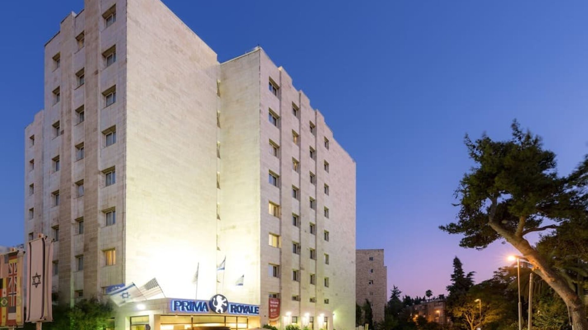 Hotel exterior at night at Prima Royale Hotel.