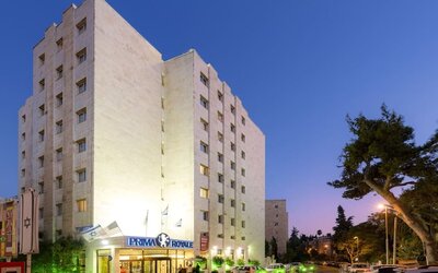 Hotel exterior at night at Prima Royale Hotel.