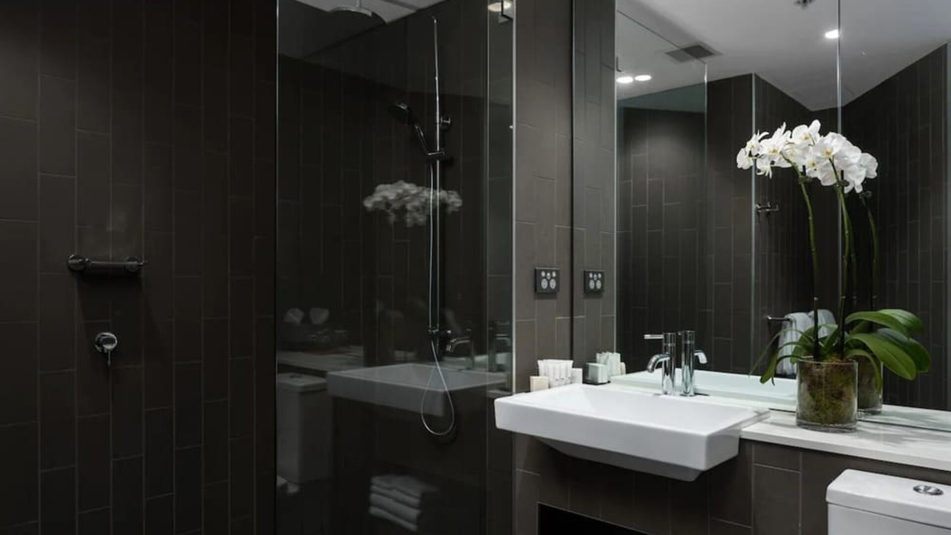 Guest bathroom with shower at Rydges Sydney Airport Hotel.