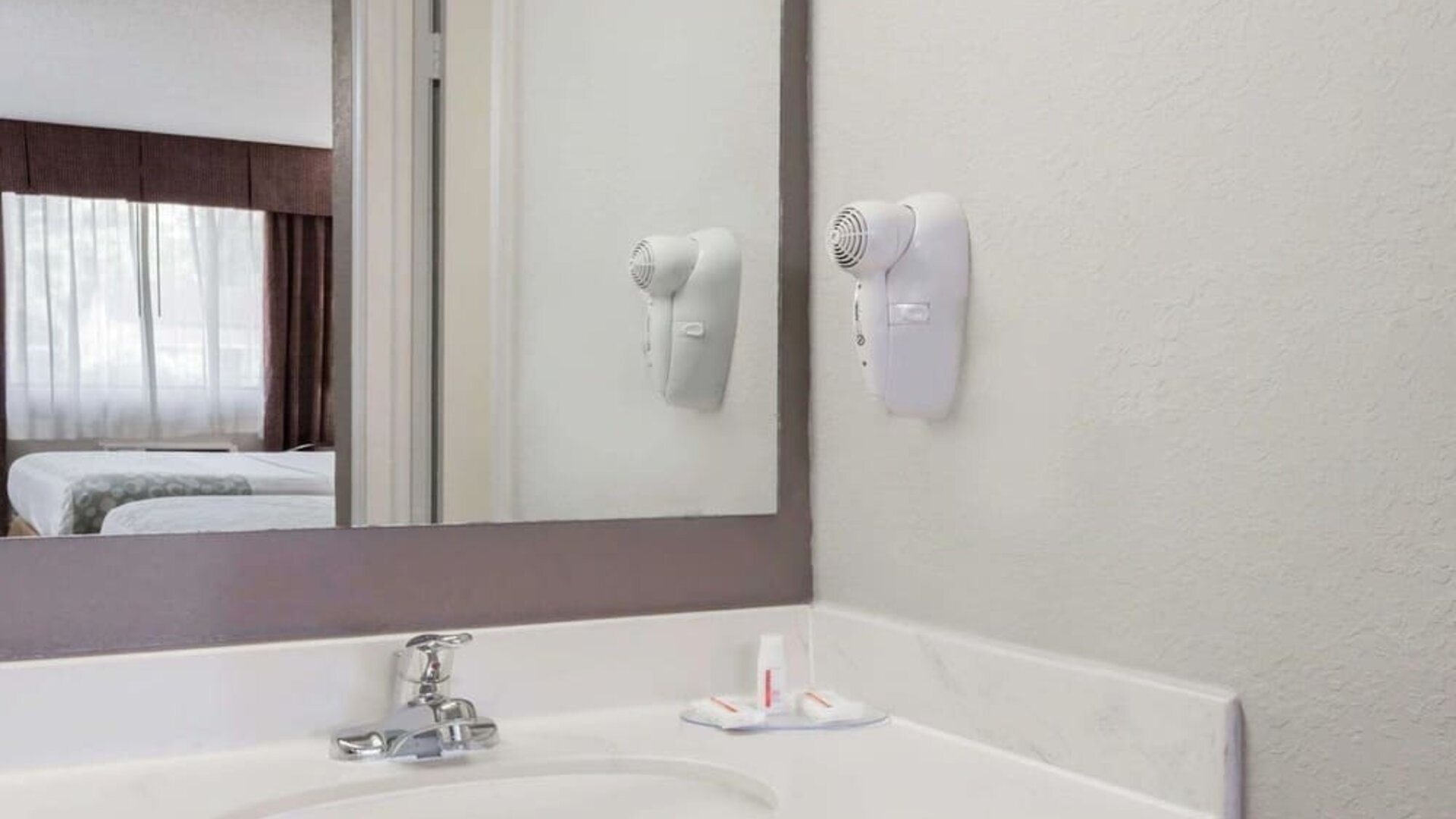 Day room with guest bathroom at Days Inn By Wyndham St Augustine/Historic Downtown.