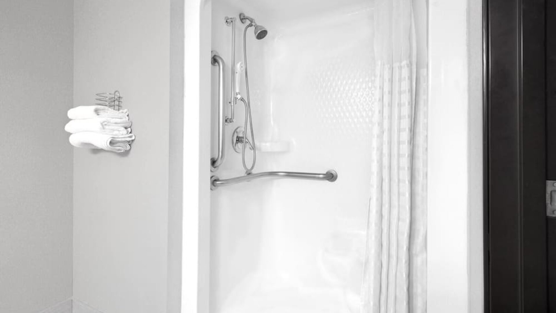 Guest bathroom with shower at Super 8 Bedford DFW Airport West.  