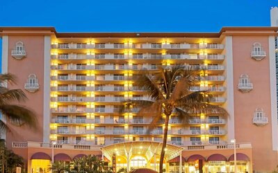 Hotel exterior at night at Ramada Plaza Marco Polo Beach Resort.