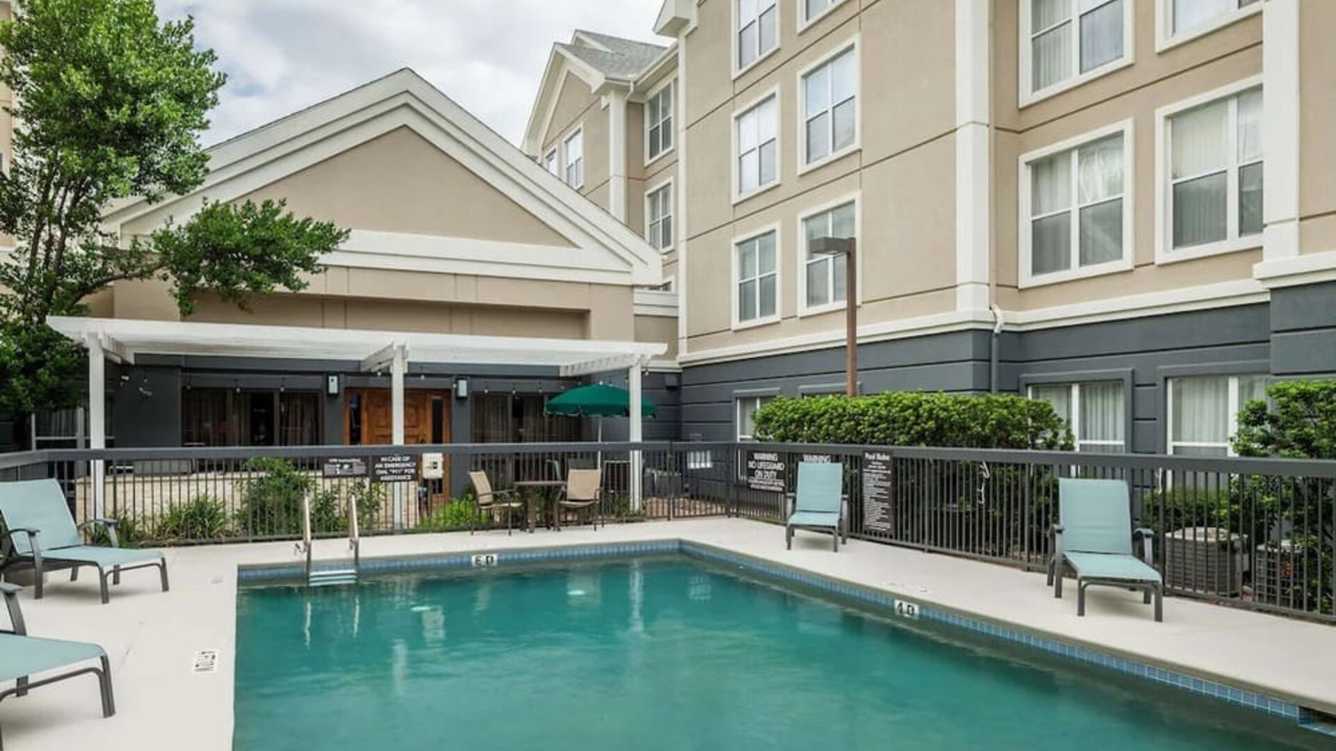 Outdoor pool with loungers at Homewood Suites By Hilton Austin NW Near The Domain.