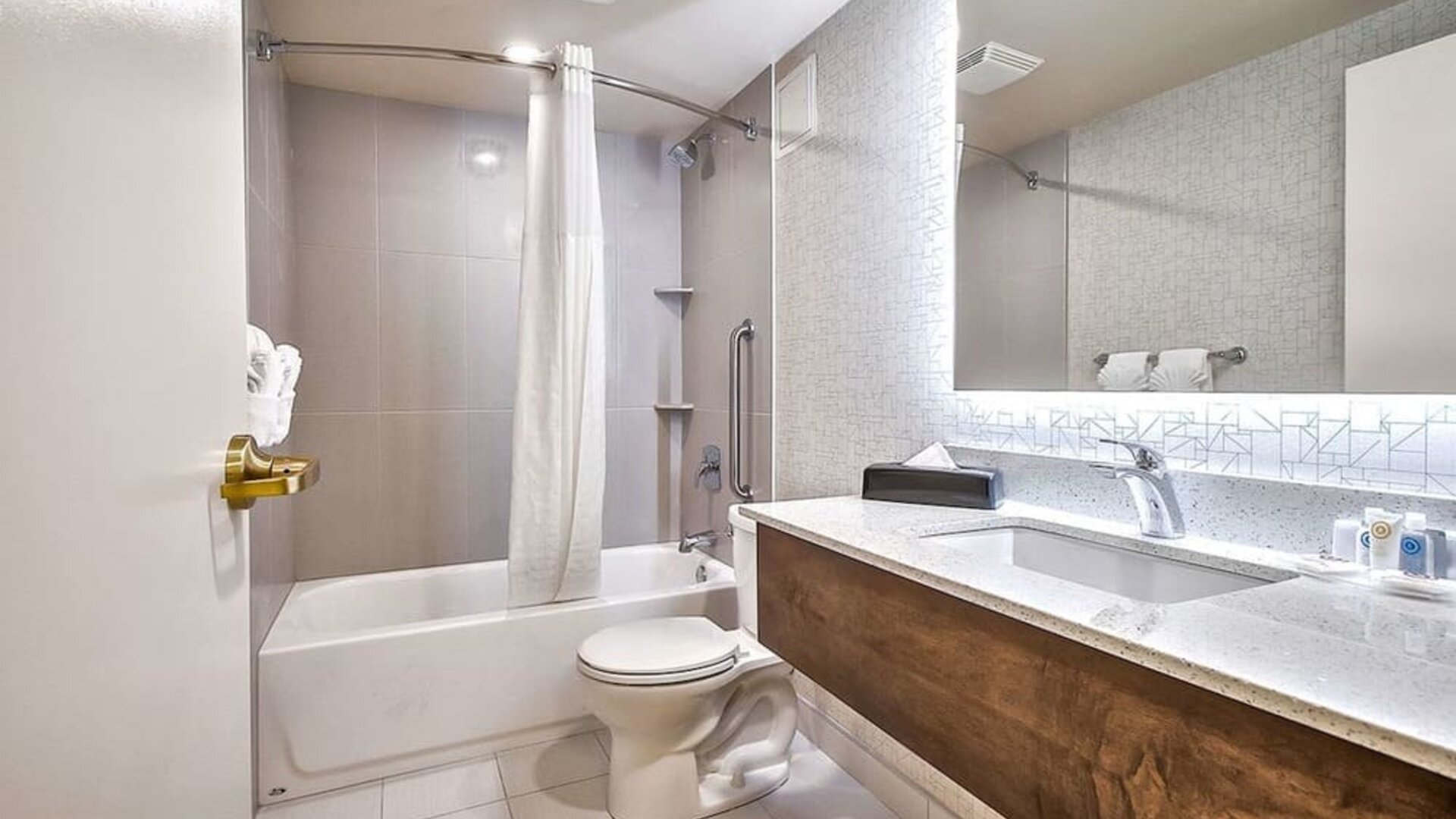 Guest bathroom with shower at Comfort Inn And Suites Calgary South.