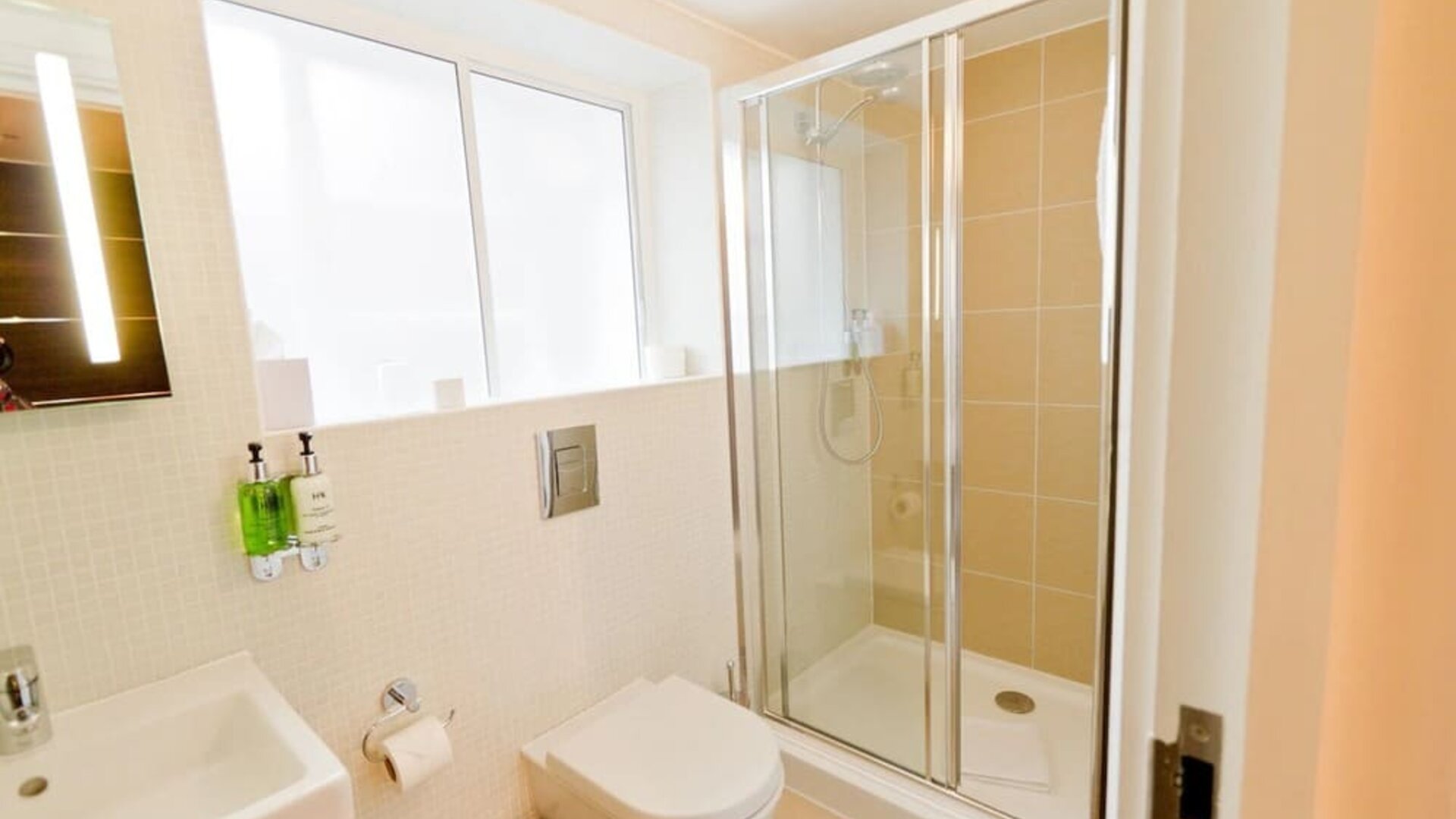 Guest bathroom with shower at The Wesley Euston Hotel.