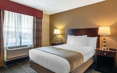 Comfortable king guest room featuring plush bedding, modern furnishings, and convenient in-room amenities at Best Western Braintree.