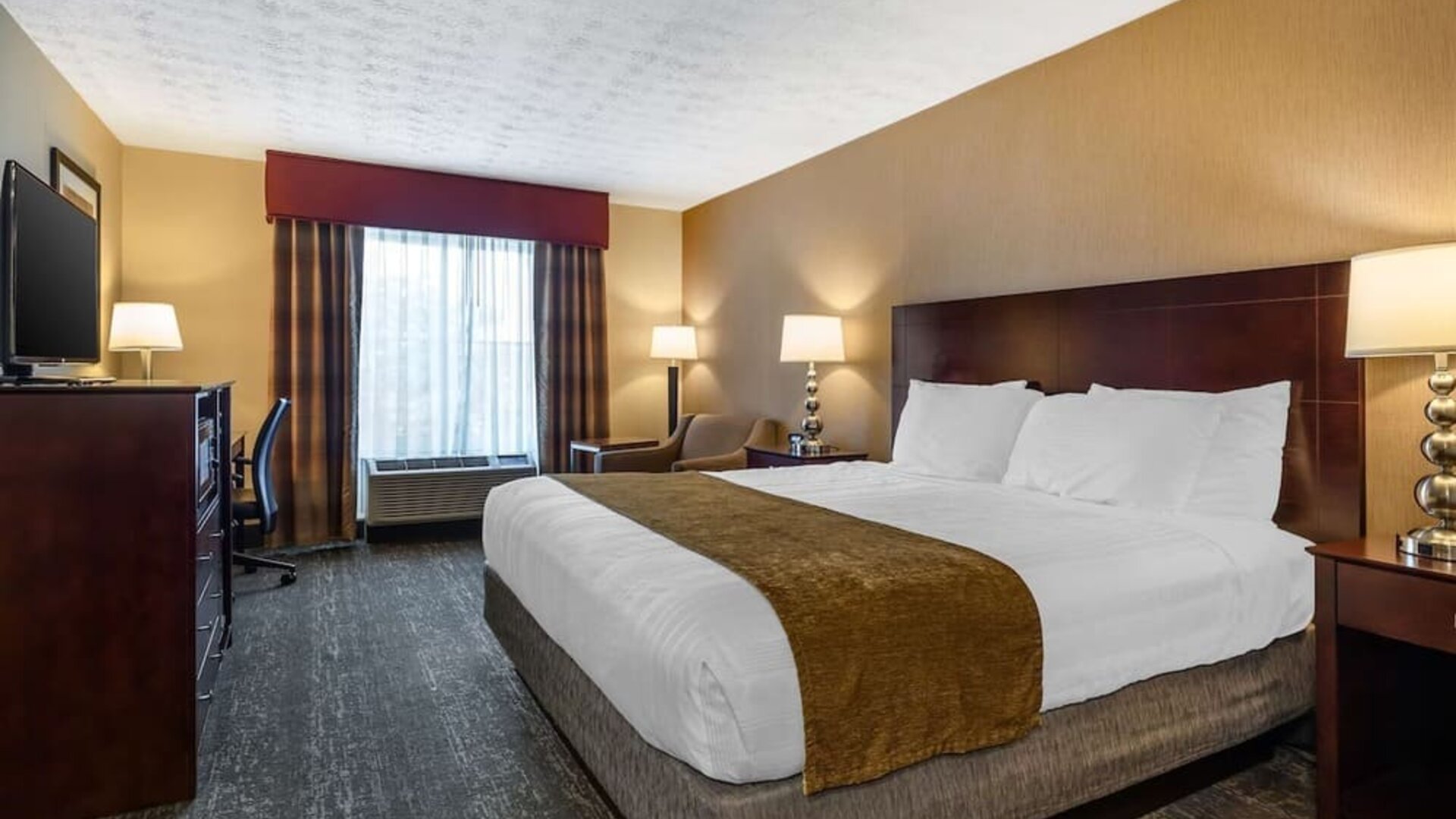 Bright guest room featuring natural light, king bed, workspace, and modern amenities at Best Western Braintree.