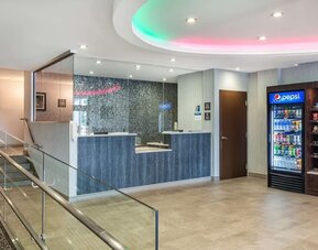 Welcoming lobby lounge with comfortable seating, snack station, and contemporary design at Best Western Braintree.