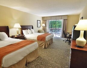 Sturbridge Host Hotel.
Double queen guest room offering comfortable accommodations, work desk, and balcony access at Sturbridge Host Hotel.