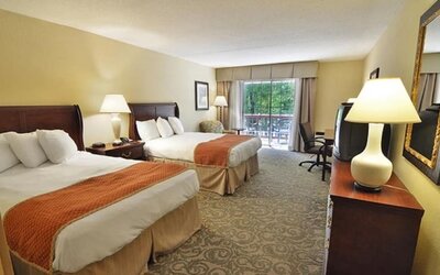 Sturbridge Host Hotel.
Double queen guest room offering comfortable accommodations, work desk, and balcony access at Sturbridge Host Hotel.