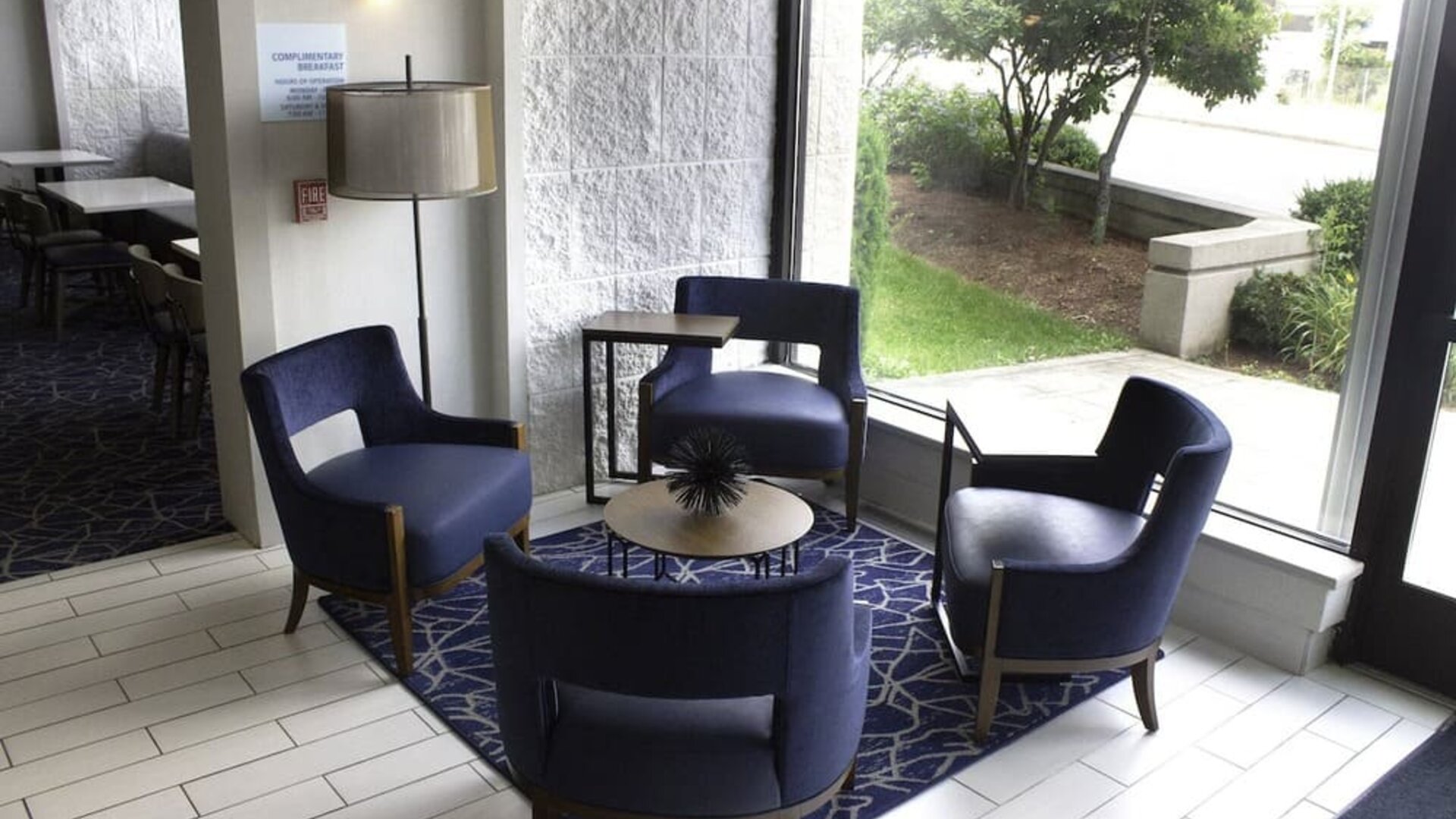 Inviting lobby seating area with modern furnishings and natural light, perfect for relaxing or meeting with colleagues at Holiday Inn Express & Suites Boston-Cambridge.