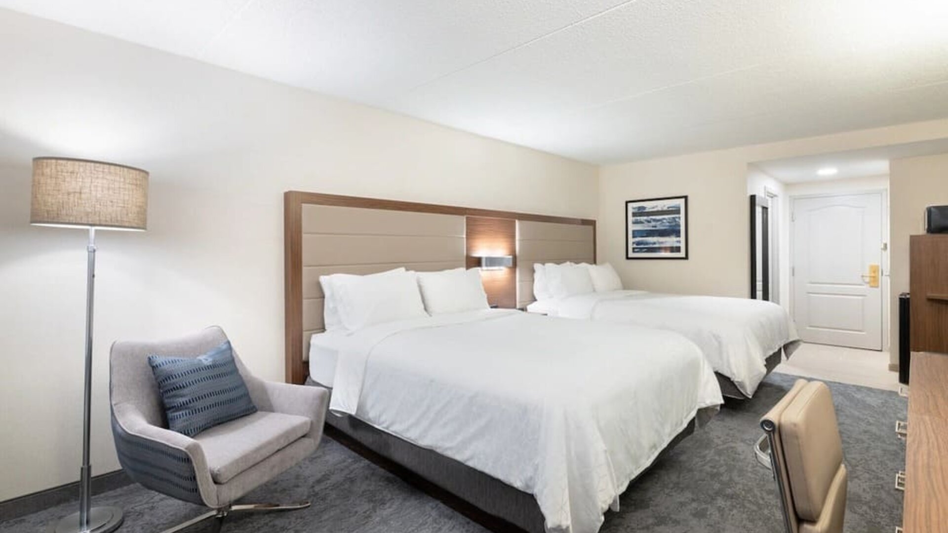 Double queen guest room featuring comfortable accommodations, contemporary furnishings, and ample space for families or groups at Holiday Inn Express & Suites Boston-Cambridge.
