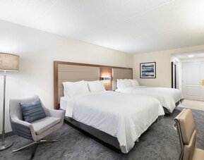 Double queen guest room featuring comfortable accommodations, contemporary furnishings, and ample space for families or groups at Holiday Inn Express & Suites Boston-Cambridge.