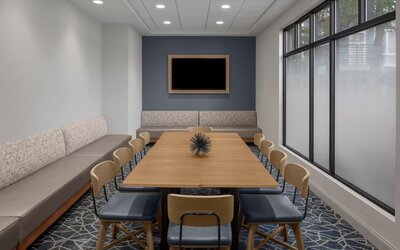 Flexible meeting room equipped for business meetings, presentations, and small group gatherings at Holiday Inn Express & Suites Boston-Cambridge.