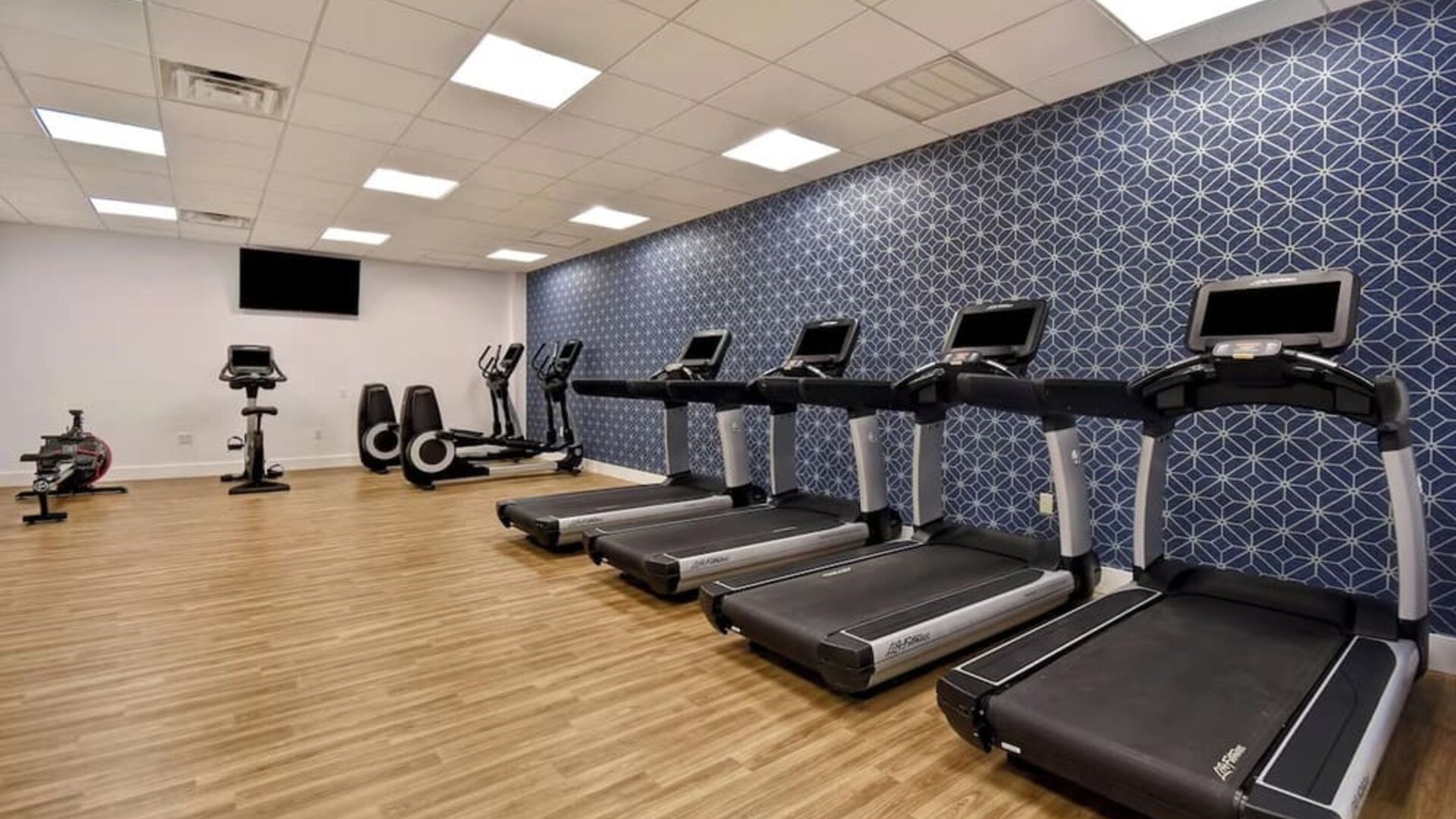 Well-equipped fitness center featuring treadmills, cardio machines, and workout equipment to help guests maintain their fitness routine at Four Points by Sheraton Boston-Newton.