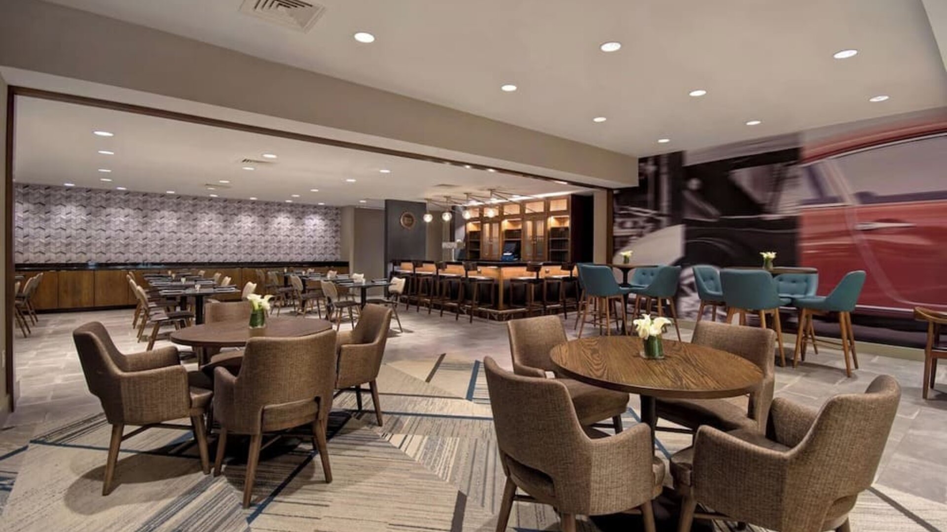 Stylish dining area with comfortable seating, modern décor, and ample space for breakfast, lunch, or evening dining at Four Points by Sheraton Boston-Newton.
