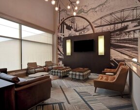 Comfortable hotel lounge featuring modern furnishings, unique décor, and inviting spaces for relaxing or socializing at Four Points by Sheraton Boston-Newton.