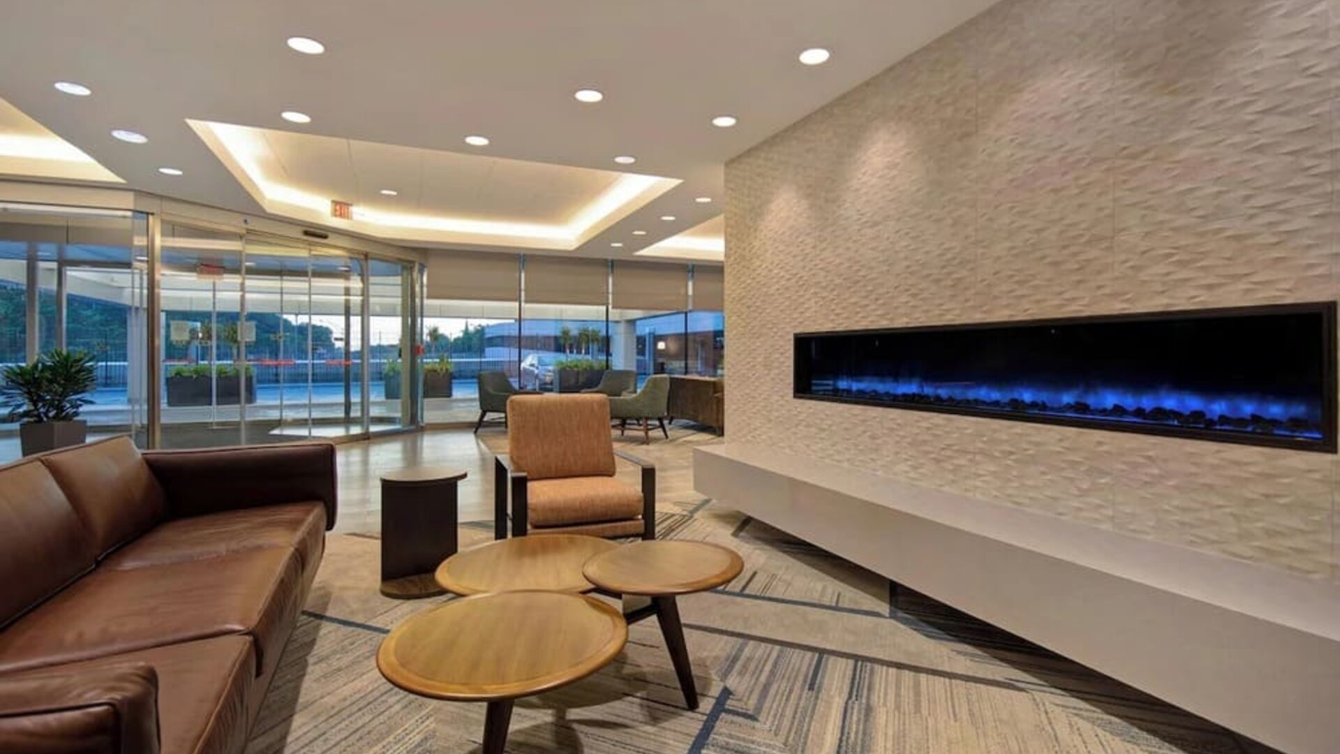 Elegant lounge area with contemporary seating, fireplace feature, and inviting gathering spaces at Four Points by Sheraton Boston-Newton.