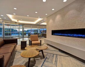 Elegant lounge area with contemporary seating, fireplace feature, and inviting gathering spaces at Four Points by Sheraton Boston-Newton.