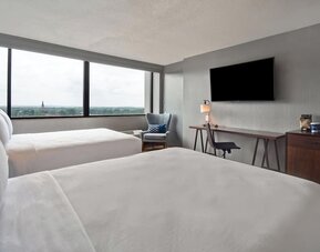 Double queen guest room offering comfortable accommodations, scenic views, and thoughtful amenities for families and groups at Four Points by Sheraton Boston-Newton.
