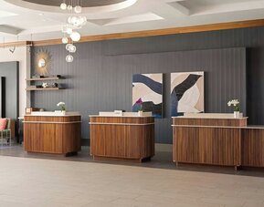 Contemporary reception desk providing efficient check-in services and a welcoming arrival experience at Courtyard by Marriott Boston Brookline.