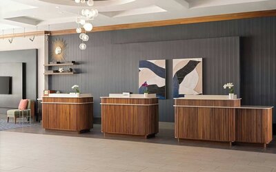 Contemporary reception desk providing efficient check-in services and a welcoming arrival experience at Courtyard by Marriott Boston Brookline.