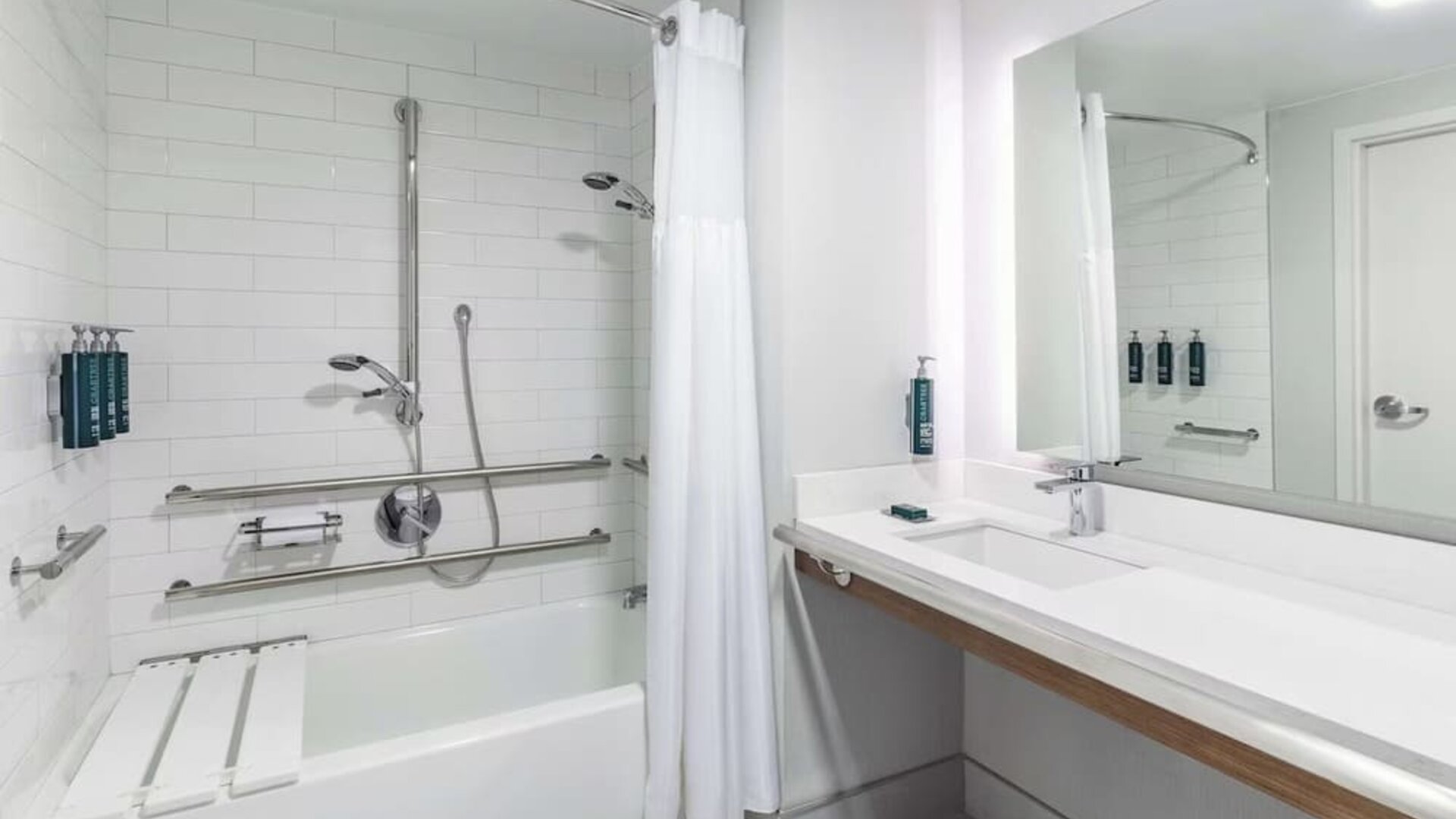 Modern guest bathroom featuring a soaking tub, accessible design elements, contemporary fixtures, and premium amenities at DoubleTree by Hilton Westborough.