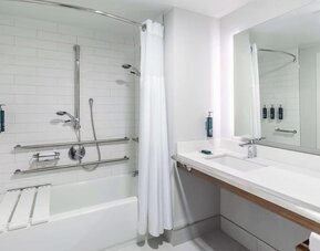 Modern guest bathroom featuring a soaking tub, accessible design elements, contemporary fixtures, and premium amenities at DoubleTree by Hilton Westborough.
